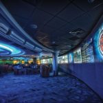 Analysts work at rows of monitors inside a modern cyber security operations centre.